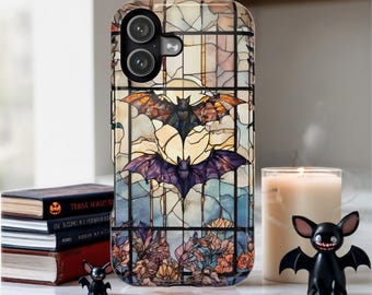 May include: A phone case with a stained-glass design featuring bats and floral elements. The case has a black camera module and a glossy finish. The design includes bats in shades of orange, purple, and black against a backdrop of blue and yellow.