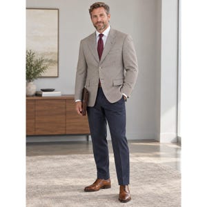 Könnte beinhalten: Ein beigefarbener Blazer mit weißem Hemd, dunkelroter Krawatte und dunkelblauer Hose. Der Blazer hat ein steigendes Revers, zwei Knöpfe und Pattentaschen. Das Outfit wird durch braune Lederschuhe und eine braune Ledermappe vervollständigt.