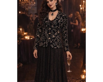 May include: A black velvet jacket with gold floral embroidery, paired with a black lace skirt. The jacket has a tailored fit with gold buttons. The outfit is worn in a dimly lit room with chandeliers and candles, creating an elegant, formal look.