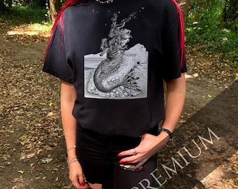 Capricorn Horror Scope Premium T-Shirt – Sea Goat on Skull Throne | Dark Earth Zodiac Tee | Comfort Colors® | Gothic Mythology | Hand-Drawn