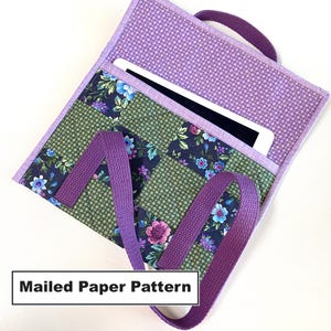May include: Purple and green fabric tablet case with a floral pattern and a purple strap. The case is open and a tablet is inside. The text "Mailed Paper Pattern" is visible at the bottom of the image.
