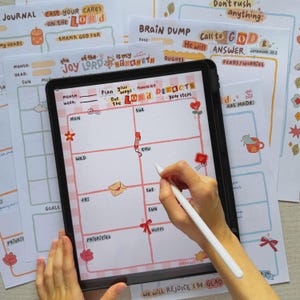 May include: A digital planner on a tablet with a grid layout, featuring handwritten notes and illustrations. The planner includes sections for the week, goals, and priorities, with the text "Plan your ways but the Lord directs your steps."