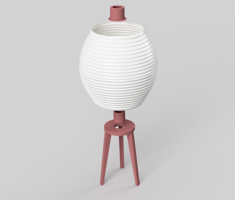 May include: A modern, white, spherical lamp with a ribbed design, supported by a three-legged, dusty rose base. The lamp has a matching dusty rose top. The lamp is a decorative lighting fixture.