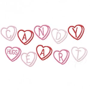 May include: A collection of embroidered candy hearts in shades of pink and red. The hearts spell out "CANDY HEART" and "HUGS". The design is on a white background. The hearts are a Valentine's Day theme.