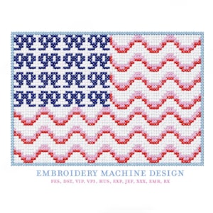May include: A cross-stitch design of the American flag. The flag features blue stars, red and white stripes, and a light blue border. The text "EMBROIDERY MACHINE DESIGN" is at the bottom, along with file type abbreviations.