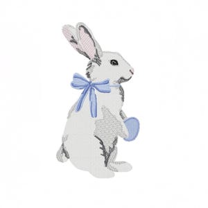 May include: Embroidered white bunny with gray accents, a blue bow, and a blue egg. The bunny is in a seated position, with its ears perked up. The design is on a white background, perfect for Easter or spring-themed crafts.