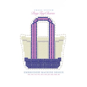 May include: Cross-stitch bag tag charm design. The bag is beige with navy blue and pink accents. The handles and bottom of the bag are navy blue. The handles have a pink stripe down the middle. The text "Bag Tag Charm" is above the bag.