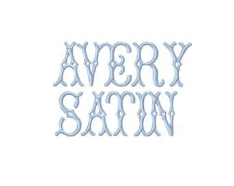 May include: Light blue embroidered text on a white background. The text reads "AVERY SATIN" in an elegant, stylized font. The letters are connected with decorative flourishes and diamond-shaped accents.
