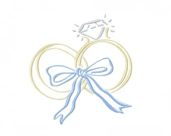 May include: An embroidered design featuring a diamond ring with a light blue bow. The ring is outlined in a soft yellow, and the diamond is a light blue color. The design is on a white background.