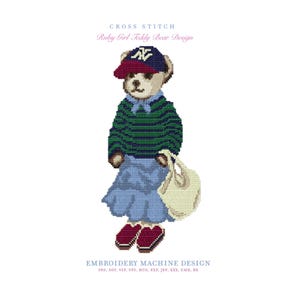 May include: A cross stitch embroidery machine design of a teddy bear wearing a navy and red baseball cap with NY logo, a green and navy striped sweater, a light blue skirt, and red shoes, carrying a cream tote bag. Text reads CROSS STITCH.