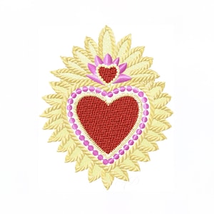 Könnte beinhalten: Gesticktes Design mit einem roten Herz mit einem rosa Perlenrand, vor einem goldfarbenen, sonnenstrahlenartigen Hintergrund. Ein kleineres Herz in Rosa sitzt über dem größeren Herz, mit einem hellgelben Rand. Das Design befindet sich auf weißem Hintergrund.