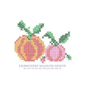 May include: A cross-stitch embroidery machine design featuring two fruits with green leaves. The larger fruit is orange and red, while the smaller fruit is pink. The text reads EMBROIDERY MACHINE DESIGN followed by PES, DST, VIP, VP3, HUS, EXP, JEF, XXX, EMB, BX.