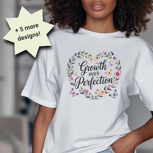 May include: White t-shirt with the text "Growth over Perfection" in a floral heart design. The shirt has short sleeves and is paired with denim shorts. The image also shows a "+ 5 more designs!" graphic.