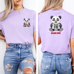 May include: A light purple t-shirt featuring a cartoon panda bear graphic. The front of the shirt has a panda with the text "see back". The back of the shirt has a panda holding a QR code with the text "scan me".