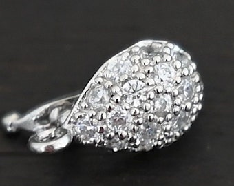 May include: Silver-toned pendant clasp with a teardrop shape and a clear crystal design.