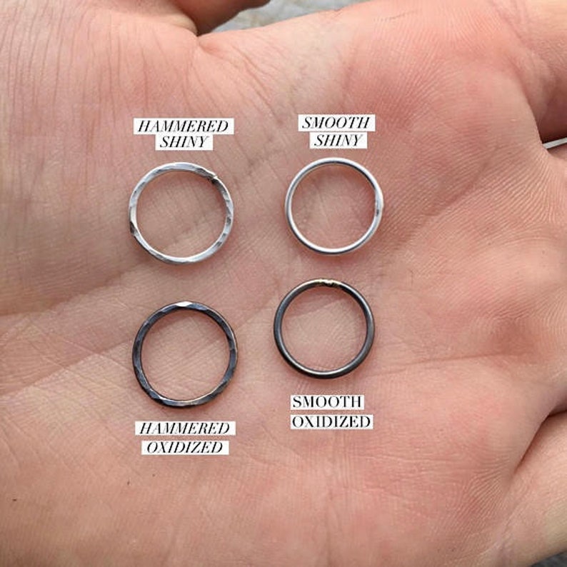 May include: Four metal rings in different finishes: hammered shiny, smooth shiny, hammered oxidized, and smooth oxidized.