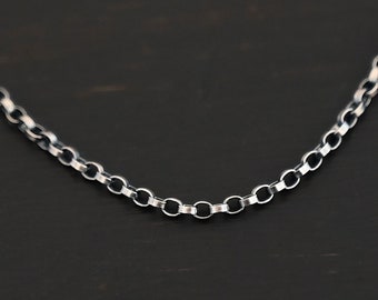 May include: A silver chain necklace with a delicate, round link design.