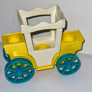 May include: A yellow toy carriage with a white top and blue wheels. The carriage has two seats and a handle on the top.