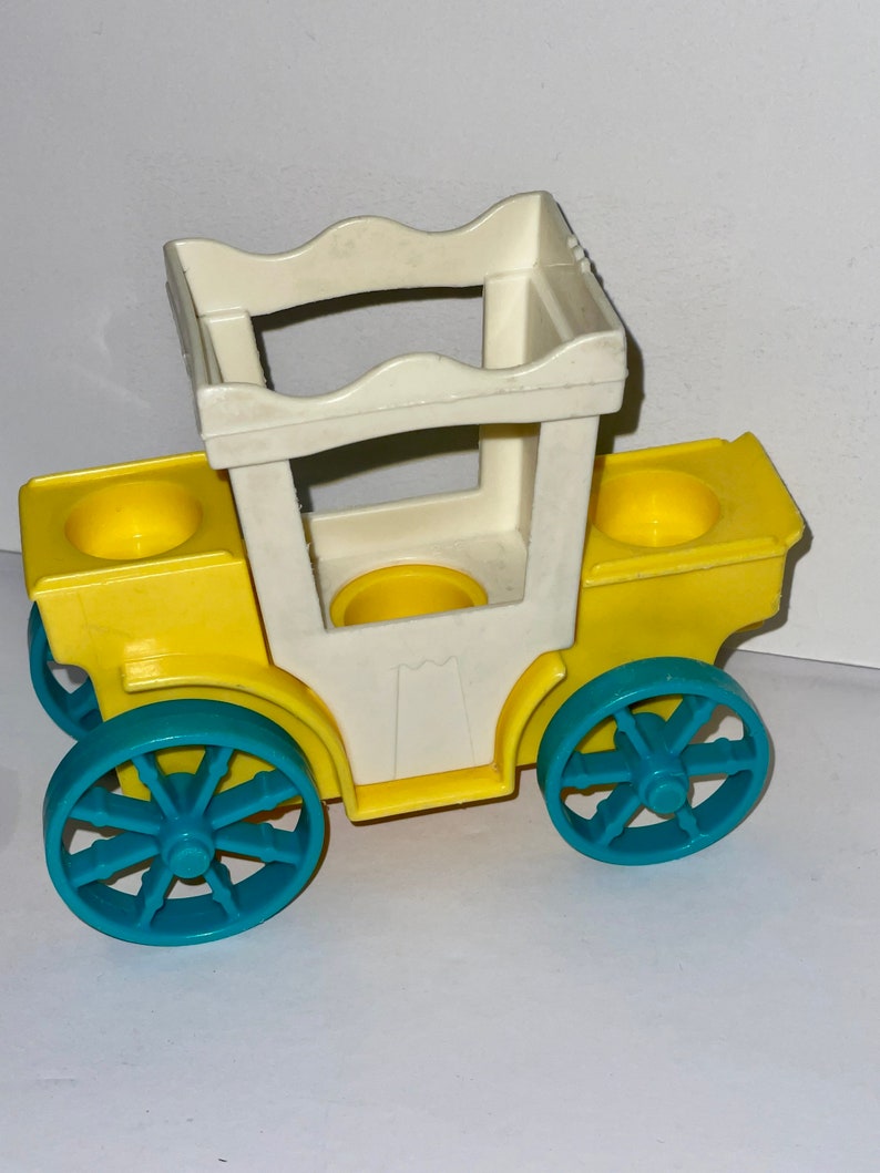 May include: A yellow toy carriage with a white top and blue wheels. The carriage has two seats and a handle on the top.