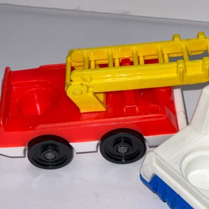 May include: A red and white toy fire truck with a yellow ladder. The truck has black wheels and a white base. The ladder is raised and has a white handle.