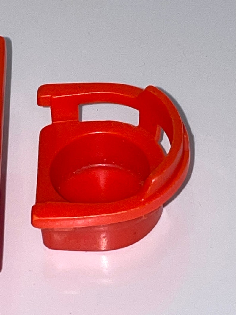 Pu&ograve; includere: Una sedia di plastica di colore rosso brillante con schienale arrotondato e un solo bracciolo. La sedia &egrave; progettata per bambini piccoli ed &egrave; un giocattolo classico.