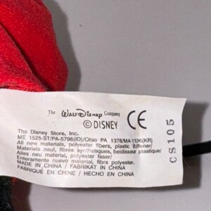 May include: White tag with black text. The Walt Disney Company, &copy;DISNEY, CE, CS105. The Disney Store, Inc. ME 1525-ST/PA-5796(ID)/Ohio PA 1378/MA-1336(KR) All new materials, polyester fibers, plastic stiffener. Materiels neuf, fibres synthetiques, beidisseur plastique/ Alles neu material, polyester faser/ Enteramente nuevo material, fibra polyester. MADE IN CHINA FABRIKAT IN CHINA FABRIQUE EN CHINE / HECHO EN CHINA