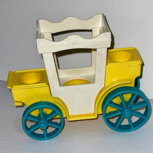 May include: A yellow toy carriage with a white roof and blue wheels. The carriage has two seats and a handle on the back.