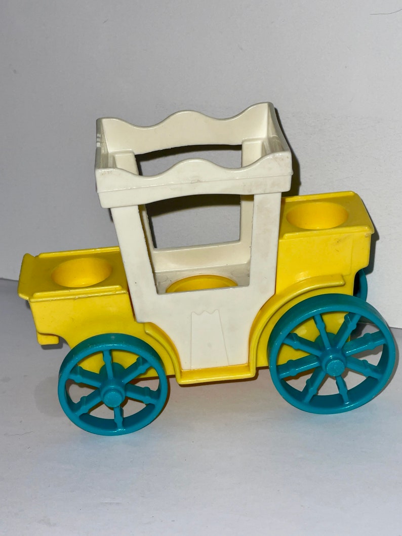 May include: A yellow toy carriage with a white roof and blue wheels. The carriage has two seats and a handle on the back.