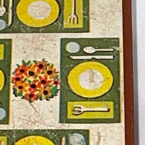 May include: A vintage illustration of a table setting with plates, silverware, and a floral centerpiece. The illustration is in a retro style with a green and yellow color scheme.