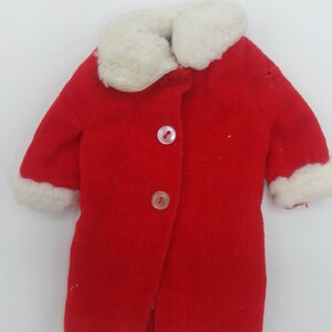 May include: Red coat with a white faux fur collar and cuffs. The coat has three buttons down the front.