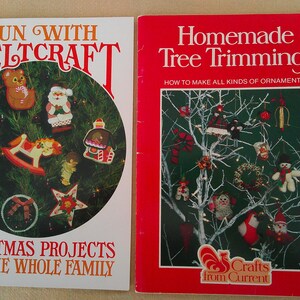 May include: Two vintage Christmas craft books. The book on the left is titled "Fun with Feltcraft" and features felt Christmas ornaments. The book on the right is titled "Homemade Tree Trimmings" and shows various ornaments.