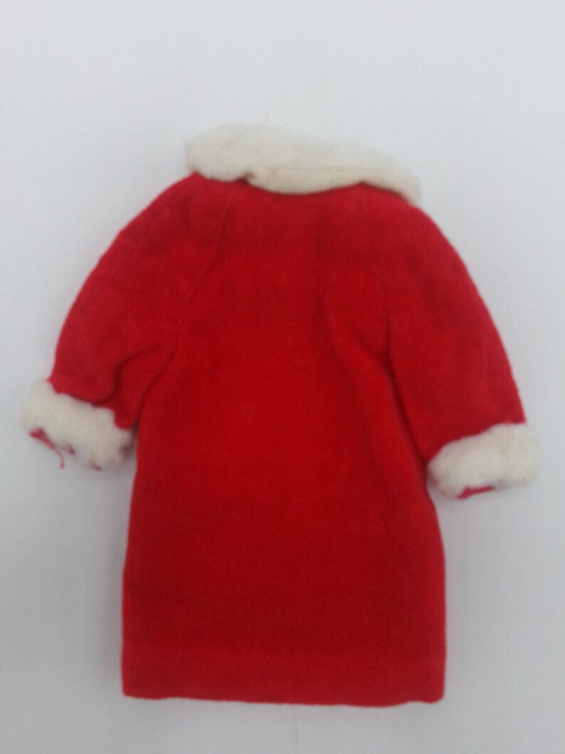 May include: Red coat with white fur trim around the collar and cuffs.