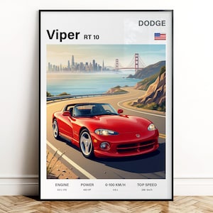 Puede incluir: Impresión enmarcada de un coche deportivo rojo Dodge Viper RT 10 en una carretera costera, con un horizonte urbano y el Golden Gate Bridge de fondo. La impresión incluye especificaciones de motor, potencia, 0-100 km/h y velocidad máxima. La bandera americana también es visible.