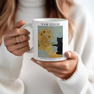 May include: White ceramic mug featuring a print of Van Gogh's "Sunflowers (Third Version)" painting, with a black cat. The mug has the text "VAN GOGH" at the top and "SUNFLOWERS (THIRD VERSION) - 1888" at the bottom.