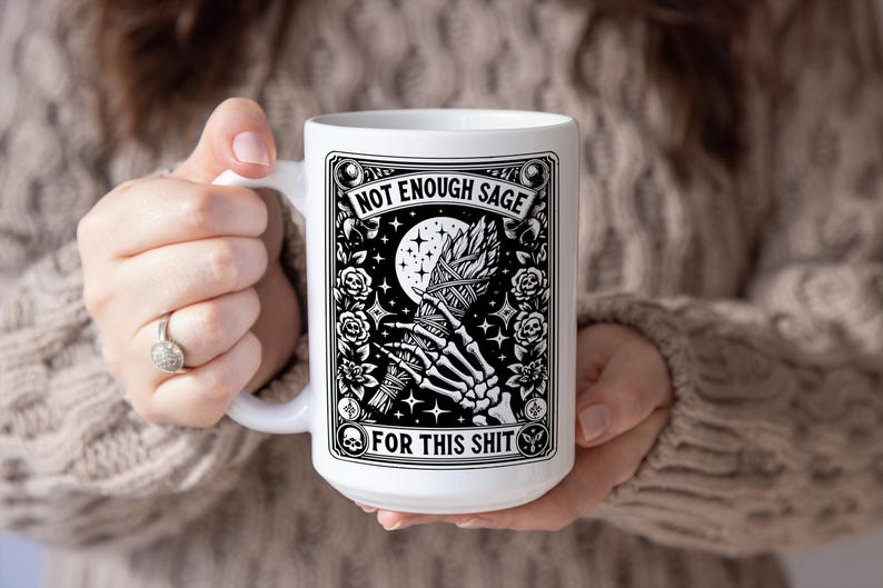 May include: White ceramic mug with a black and white graphic design. The design features a skeleton hand holding a bundle of sage, a crescent moon, roses, and the text "NOT ENOUGH SAGE FOR THIS SHIT."