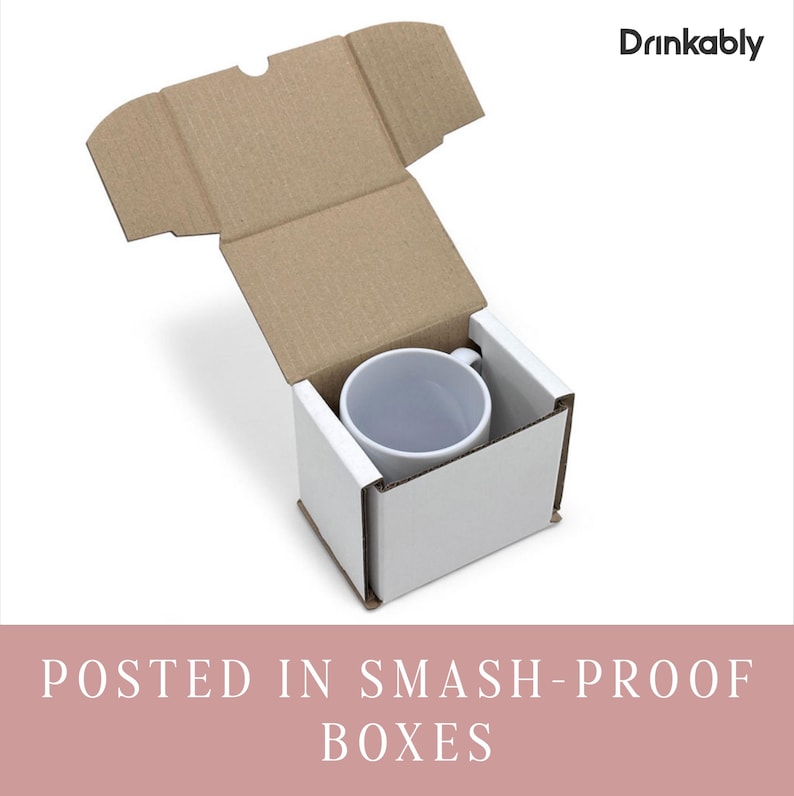 May include: A white ceramic mug inside a white box, nestled within a brown cardboard shipping box. The top of the shipping box is open. The text "Drinkably" is in the upper right corner. The text "POSTED IN SMASH-PROOF BOXES" is at the bottom.