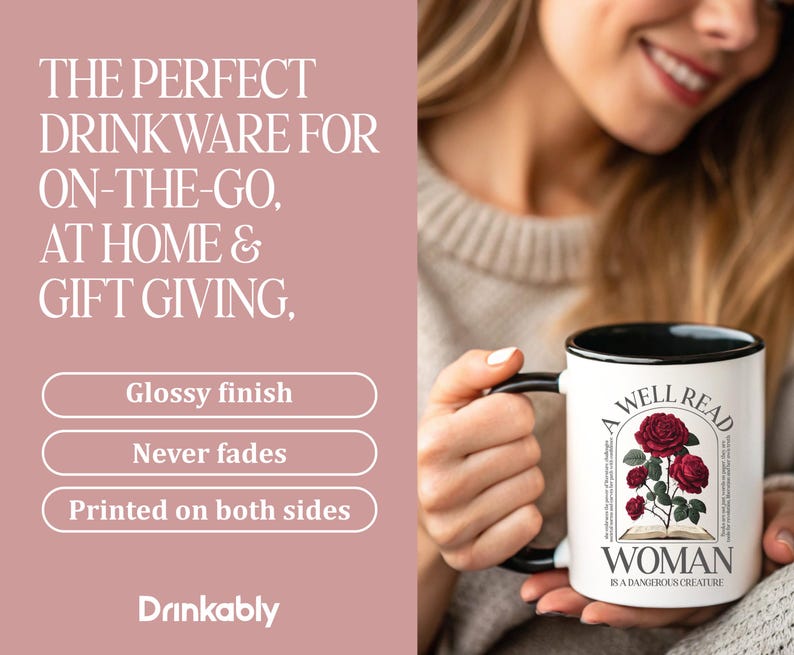 May include: White ceramic mug with a black handle and rim, featuring the text "A Well Read Woman is a Dangerous Creature" and a floral design. The mug is printed on both sides and has a glossy finish.