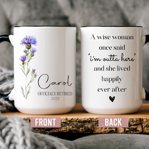 May include: White ceramic mug with a black handle and rim. The front features a floral design and the name "Carol" with "OFFICIALLY RETIRED 2025". The back reads "A wise woman once said 'I'm outta here' and she lived happily ever after."
