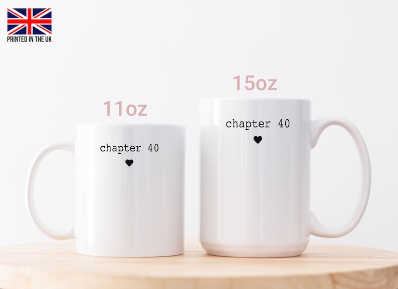 May include: Two white ceramic mugs with black text that reads "chapter 40" and a small black heart. The mugs are labeled "11oz" and "15oz". The image includes a small British flag in the upper left corner.