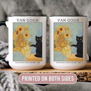 May include: White ceramic mug with black handle featuring Van Gogh's "Sunflowers" painting and a black cat. The mug has the text "VAN GOGH" and "PRINTED ON BOTH SIDES". A decorative item for art and cat lovers.