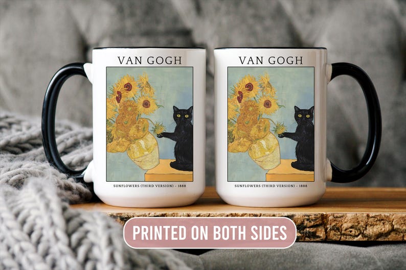 May include: White ceramic mug with black handle featuring Van Gogh's "Sunflowers" painting and a black cat. The mug has the text "VAN GOGH" and "PRINTED ON BOTH SIDES". A decorative item for art and cat lovers.