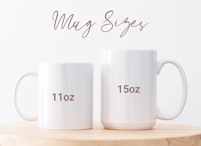 May include: Two white ceramic mugs of different sizes are displayed on a wooden surface. The smaller mug is labeled "11oz" and the larger mug is labeled "15oz". The text "Mug Sizes" is written above the mugs in a cursive font.