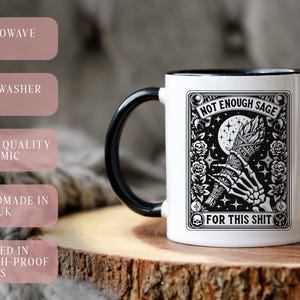 May include: White ceramic mug with a black handle and rim, featuring a black and white graphic with the text "NOT ENOUGH SAGE FOR THIS SHIT." The mug is labeled as microwave and dishwasher safe, and handmade in the UK.