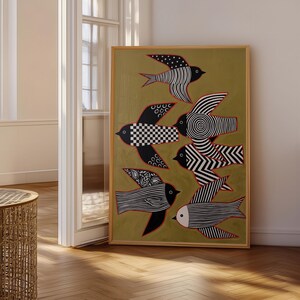 May include: A framed rectangular wall art piece featuring a mustard yellow background with six stylized birds. Each bird displays distinct black and white patterns, including stripes, polka dots, checkerboards, and concentric circles, outlined in thin red lines.