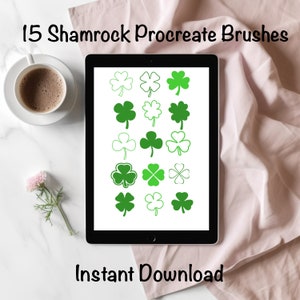 May include: A digital tablet screen displaying 15 shamrock Procreate brushes. The shamrocks are green and white and are arranged in a grid pattern. The text "15 Shamrock Procreate Brushes" is at the top of the screen and the text "Instant Download" is at the bottom of the screen.