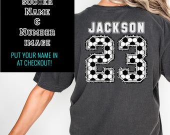 Könnte beinhalten: Ein schwarzes T-Shirt mit einem weißen Fußball-Design und dem Text "JACKSON 23".