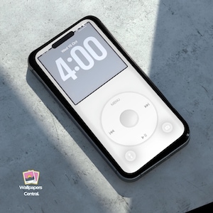 May include: A smartphone with a white screen displaying the time 4:00. The phone has a white interface with a circular control pad and a black border. The phone is on a gray surface.