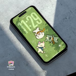 May include: A smartphone displays a green wallpaper with cartoon animals wearing scarves. The time 11:29 is displayed in large numbers. The phone is on a gray surface. The logo "Wallpapers Central" is in the bottom left corner.