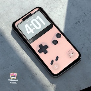Puede incluir: Una funda rosa para teléfono diseñada para parecerse a una consola de juegos portátil retro. La funda presenta un mando direccional negro, botones A y B y un altavoz. La pantalla del teléfono muestra la hora, 4:01, y la fecha, miércoles 16 de octubre.