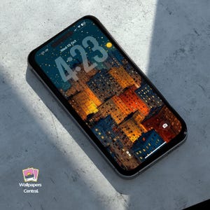Puede incluir: Un smartphone con un fondo de pantalla de un paisaje urbano con edificios iluminados en tonos naranja, azul y amarillo. La hora que se muestra en la pantalla es 4:23. El teléfono tiene un marco negro y está sobre una superficie gris.